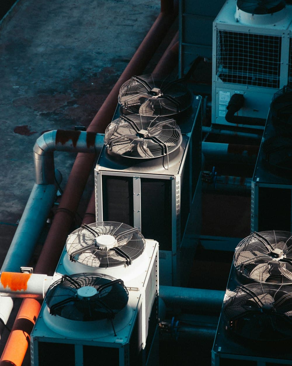 HVAC technician among rooftop condenser units